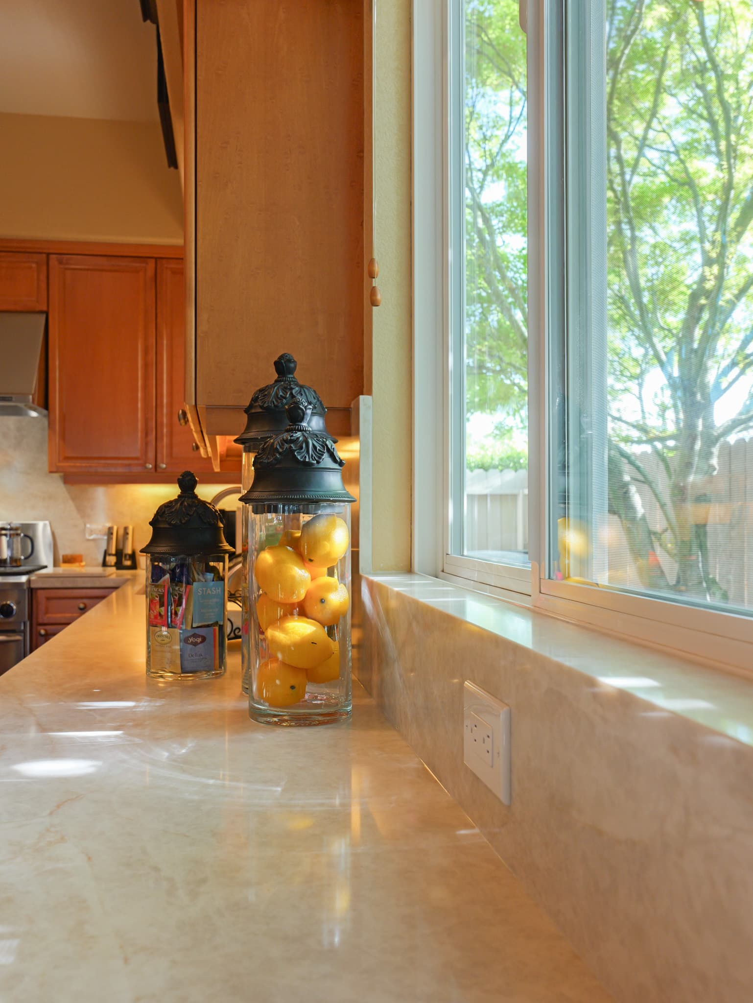 Kitchen Remodel in Roseville — marble countertop, raised-panel cabinets, natural-stone backsplash